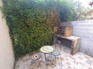 an outdoor patio with a table and chairs and a grill at Meular in Pilar