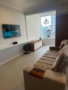 a living room with a couch and a large window at 1101 Barra Salvador - Excelente para o Carnaval! in Salvador