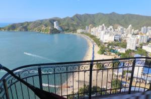 a view of a beach from a balcony at Edificio El Peñon del Rodadero Apartamento Playa in Santa Marta