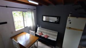 a dining room with a table and a refrigerator at Meular in Pilar