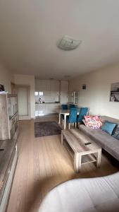 a living room with a couch and a table at City kvart 2 bedroom apartment in Podgorica