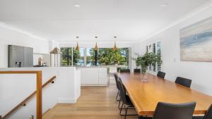 a dining room and kitchen with a table and chairs at Rivers Edge Oasis -Karuah, Infinity Pool and Private Cinema room in Karuah