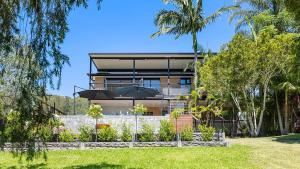 a house with a garden in front of it at Rivers Edge Oasis -Karuah, Infinity Pool and Private Cinema room in Karuah