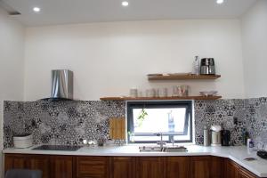 a kitchen with a sink and a window at Chiri House in Khu Chi Lăng +17 photos