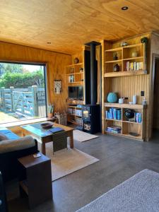 a living room with a couch and a table at Tau Studio - Boutique Accommodation in Ohakune