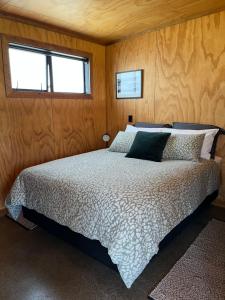 a bedroom with a bed and a window at Tau Studio - Boutique Accommodation in Ohakune