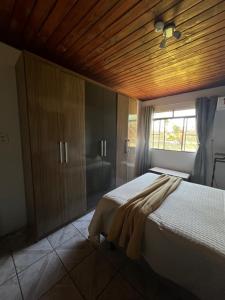 a bedroom with two beds and a window at Chácara Revoar in São Gabriel