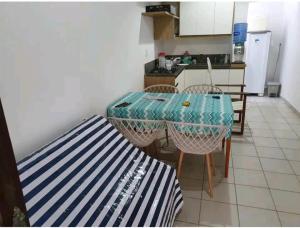 a kitchen with a table and chairs in a room at Lucena praia in Lucena