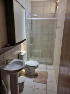 a bathroom with a toilet and a sink and a shower at Lucena praia in Lucena