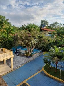 an overhead view of a resort swimming pool with trees at Mirante do Maracajá in Mosqueiro