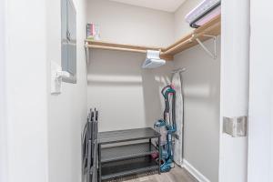 a walk in closet with a bench and tools at Downtown Kimmswick Studio-Renovated-Prime Location in Imperial +4 photos
