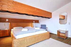 a bedroom with a large bed with a wooden ceiling at Ferienwohnung Breitschaft-Mühlberger in Reit im Winkl
