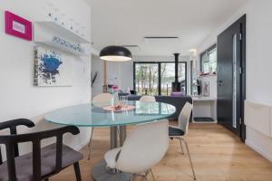 a dining room and kitchen with a glass table and chairs at Holiday Home by Lake Wise ka with Sauna in Wisełka