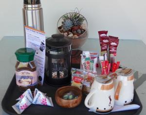 a table with a coffee maker and some food at Rooisand Desert Ranch in Chausib