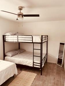 two bunk beds in a room with a ceiling at Cozy 2-BR Retreat in Kingman, AZ in Kingman