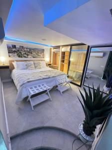 a bedroom with a bed and a potted plant at Luxury Apartment Jacuzzi Air Conditioning Fireplace and King Bed in Medellín