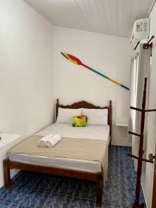 a bedroom with a bed with a kite on the wall at La Mar Paraty Hospedaria 01 in Paraty
