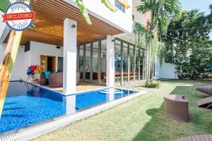 a house with a swimming pool in the yard at Perfect Son Tra Beach Villa Da Nang with sea view in Danang