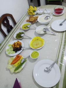 a table with many plates of food on it at Nature Room - Habaraduwa in Habaraduwa +14 photos