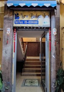 a building with a sign for a new buffalo grill at New Budget Inn Hotel in Cukai