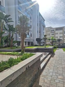 a walkway in front of a building at Bel appartement familial résidence sécurisée in Casablanca