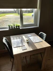 a wooden table in a room with a window at Ballyhoura Country Retreat 1 Bedroom Apartment in Kildorrery