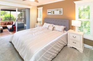 a bedroom with a large white bed and a living room at 1209 Marco Island in Marco Island +20 photos