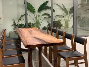 a wooden table and chairs in a room with plants at Mey lnn Hotel Phu Quoc Island in Phu Quoc +75 photos
