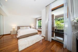a bedroom with a bed and a large window at Luxury 2 Bedrooms Villa Bangtao in Ban Pa Khlok +27 photos