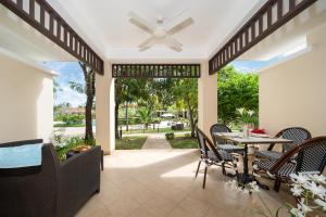 a patio with a table and chairs and a ceiling fan at Luxury 2 Bedrooms Villa Bangtao in Ban Pa Khlok