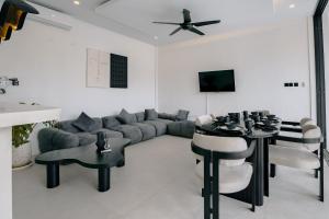 a living room with a couch and a table and chairs at Spacious luxury Canggu villa 3BR crate cafe, beach 10min in Canggu