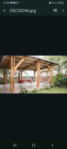 a picture of a wooden pavilion with two tables at La grenadine in Sainte-Anne-les Hauts +9 photos