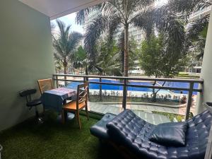 a living room with a view of the pool at Azure Paranaque near Airport in Manila +12 photos