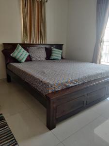 a wooden bed with pillows on it in a room at Sivarama garden resort 5star stay , swimming pool,8 BHK , bheemili beach road Bheemunipatam in Visakhapatnam