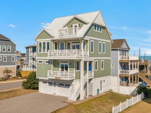 a large house with green and white at Shore Sounds Fun in Surf City