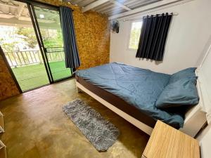 a bedroom with a bed and a large window at Hostel Ko Kut in Ko Kood