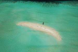 a person standing on an island in the ocean at Aldy homestay in Yennanas Besir