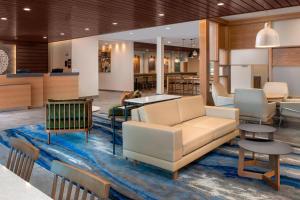 a lobby with a couch and chairs and tables at Fairfield Inn & Suites by Marriott New Orleans Metairie in Metairie