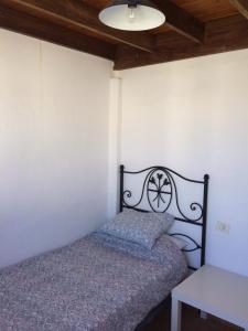 a small bedroom with a bed and a table at Casa Chanin in Punta Mujeres
