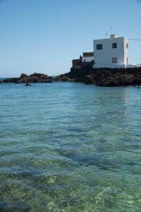 a large body of water with a building in the background at Casa Chanin in Punta Mujeres