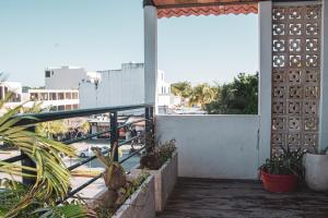 a balcony with plants and a view of a street at Hotel Tulum Centro, Party Hotel in Tulum