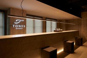 a counter in a store with a sign on the wall at TONES Osaka in Osaka