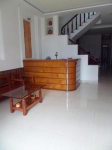 a living room with a couch and a table and stairs at Thanh Hoa Hotel Nha Trang in Nha Trang