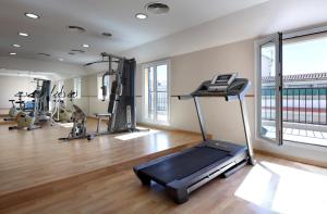 a gym with a treadmill and several exercise bikes at Exe Tartessos in Huelva
