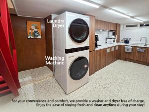 a kitchen with a washer and dryer in a room at AccessHouse in Seoul