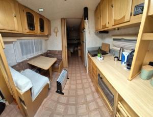 a small kitchen and dining area of an rv at Trysil Campingvogn Ski in-out in Trysil