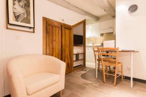 a living room with a chair and a table and a kitchen at COLMAR city center Little Venise - GITE DE LEA - in Colmar