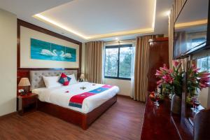 a bedroom with a large bed and a large window at Sapa Hidden Gem Hotel & Spa in Sa Pa