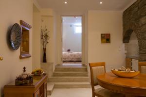 a kitchen with a table and a dining room at Andria Suites in Andros