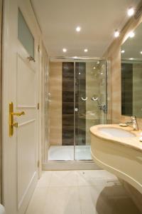 a bathroom with a shower and a sink at Andria Suites in Andros